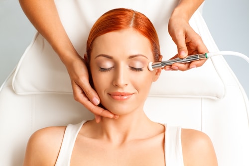 Closeup,Portrait,Of,Happy,Redheaded,Woman,Getting,Microdermabrasion,Procedure,In Aesthetic Services Milledgeville GA